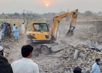 Locals gather at the site of the blast in Bannu district of Khyber Pakhtunkhwa