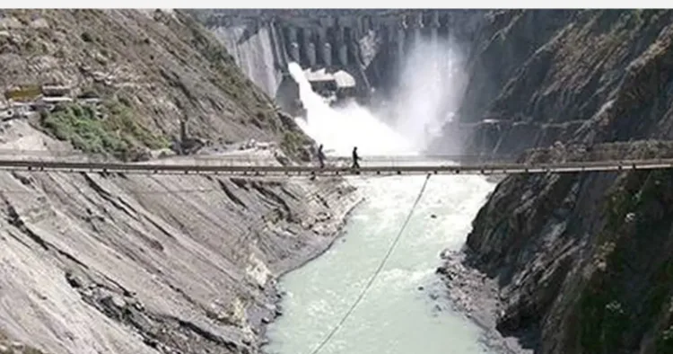 Labours walking on the bridge on top of the river Chenab