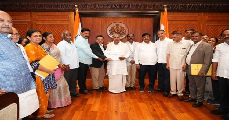 Karnataka CM Siddaramaiah receiving the report from Backward Classes Commission Chairman Madhusudan Nayak