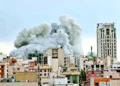 A plume of smoke rises after a strike in Tehran