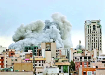 A plume of smoke rises after a strike in Tehran