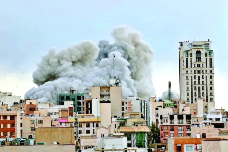 A plume of smoke rises after a strike in Tehran