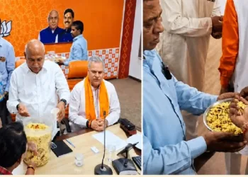 BJP supporters celebrate the win in state assembly elections by eating Jhalmuri