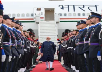 Prime Minister Narendra Modi walks past a ceremonial guard of honour after arriving in Rome for the final leg of his five-nation diplomatic tour