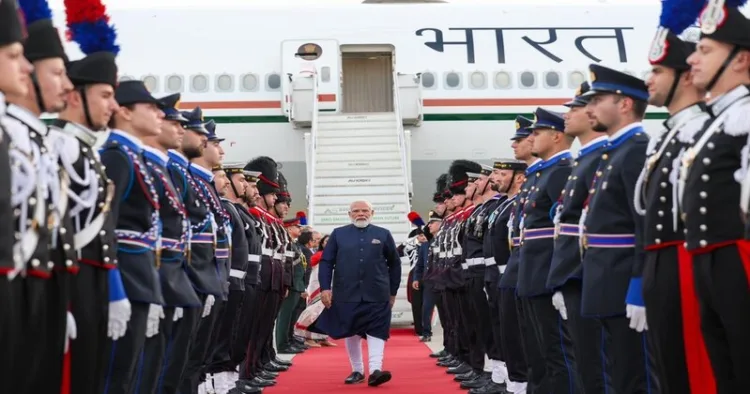 Prime Minister Narendra Modi walks past a ceremonial guard of honour after arriving in Rome for the final leg of his five-nation diplomatic tour