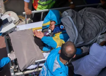 Everest Survivor being taken to the hospital on a stretcher