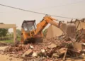 The Ghaziabad administration demolished an alleged illegal two-storey 'Mazar' on UPSIDA land in Loni, citing government land encroachment