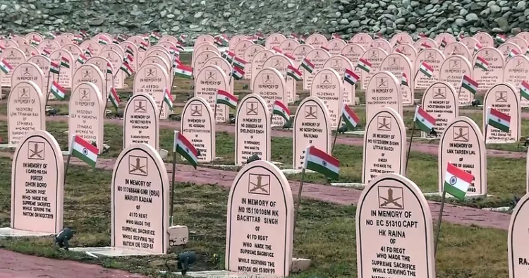 Drass, Jul 25 (ANI): A view of rows of memorial headstones adorned with National flags as preparations underway ahead of the 27th Kargil Vijay Diwas on July 26, in Drass on Saturday. (ANI Video Grab)
