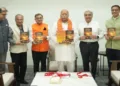 Tarun Vijay presents copy of his book 'Saffron Surge' to RSS Sarsanghchalak Dr Mohan Bhagwat