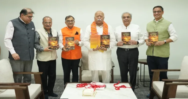 Tarun Vijay presents copy of his book 'Saffron Surge' to RSS Sarsanghchalak Dr Mohan Bhagwat