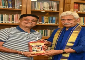 Singapore-based international journalist Sameer Mohindru seen presenting a book to J&K Governor Manoj Sinha during a courtesy call meeting at Lok Bhawan on July 6.