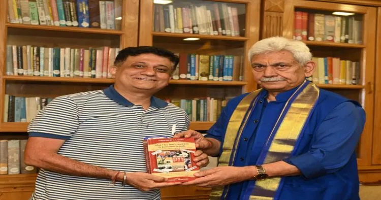 Singapore-based international journalist Sameer Mohindru seen presenting a book to J&K Governor Manoj Sinha during a courtesy call meeting at Lok Bhawan on July 6.
