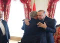 Turkish President Recep Tayyip Erdogan meets a Hamas delegation in Turkey as the late Hamas political chief Ismail Haniyeh (left) looks on