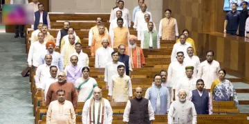 New Delhi, Aug 13 (ANI): Prime Minister Narendra Modi stands for 'Vande Mataram' before the proceedings of the Lok Sabha during the Monsoon Session of Parliament, in New Delhi on Thursday. Union Ministers Amit Shah, Rajnath Singh, Nitin Gadkari, Kiren Rijiju, Giriraj Singh, and Pralhad Joshi; Union MoS Jitendra Singh; and Union MoS (I/C) Arjun Ram Meghwal present. (Sansad TV/ANI Video Grab)