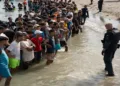 Spanish security personnel monitor migrants arriving on the coast of Ceuta amid a fresh wave of sea crossings from Morocco