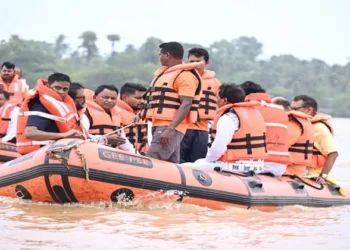 Odisha Chief Minister Mohan Charan Majhi, accompanied by other ministers, surveys flood-affected areas by boat and motorcycle to assess the situation firsthand