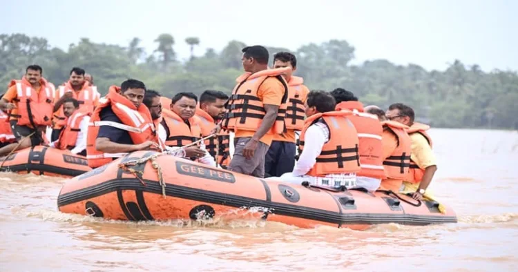 Odisha Chief Minister Mohan Charan Majhi, accompanied by other ministers, surveys flood-affected areas by boat and motorcycle to assess the situation firsthand