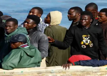 A Spanish Coast Guard vessel tows a fibreglass boat with migrants onboard to the port of Arguineguin, on the island of Gran Canaria, Spain