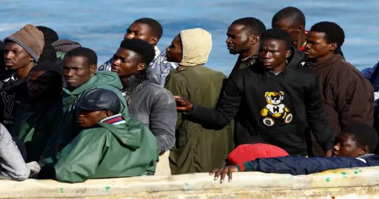 A Spanish Coast Guard vessel tows a fibreglass boat with migrants onboard to the port of Arguineguin, on the island of Gran Canaria, Spain