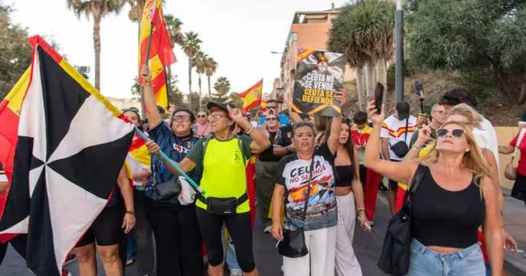 Ceuta residents wave Spanish flags and march through the streets during protests over the continuing migrant crisis in Spain’s North African enclave.