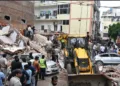 Rescue teams clear debris at the Satya Niketan building collapse site in Delhi