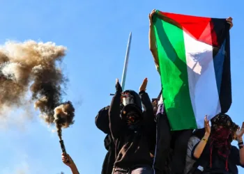 Protesters hold a Palestinian flag on the day French high school and university students attend a demonstration in Strasbourg on October 6,2026.