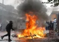 A student walks past a burning bicycle next to the Baggio High School Tuesday, Sept. 29, 2026, in Lille, France