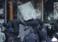 Left-Islamist protesters break the windows of a French frozen-food store in Paris