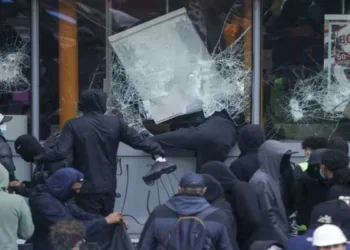 Left-Islamist protesters break the windows of a French frozen-food store in Paris