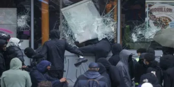Left-Islamist protesters break the windows of a French frozen-food store in Paris