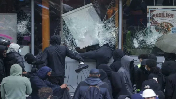Left-Islamist protesters break the windows of a French frozen-food store in Paris